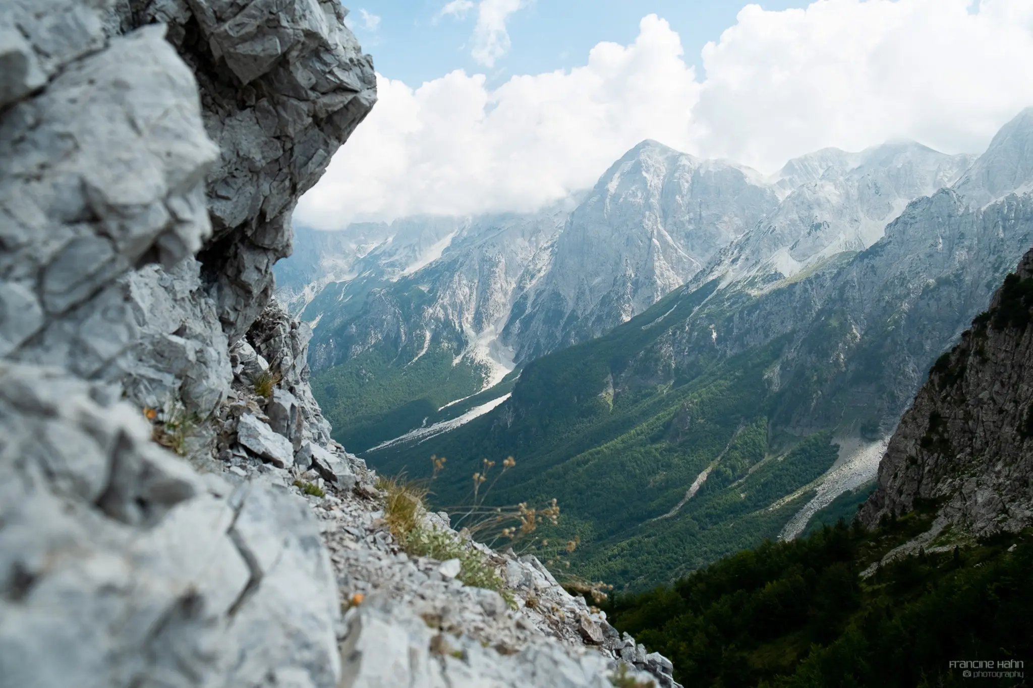 majestic mountain landscape with rocky foreground and green valleys